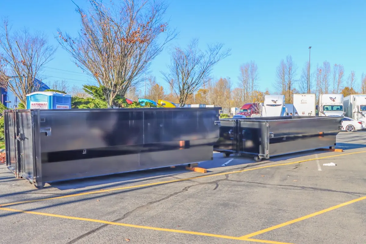 Professional dumpster rental service with roll-off container on residential driveway in Fergus Falls